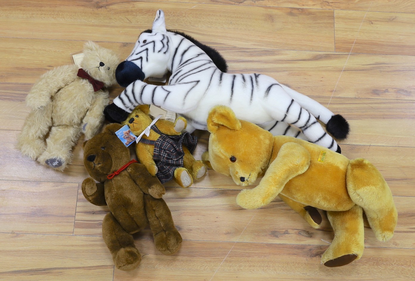 A Deans limited edition teddy Bear, boxed with three other Deans Bears and a large Merrythought Zebra